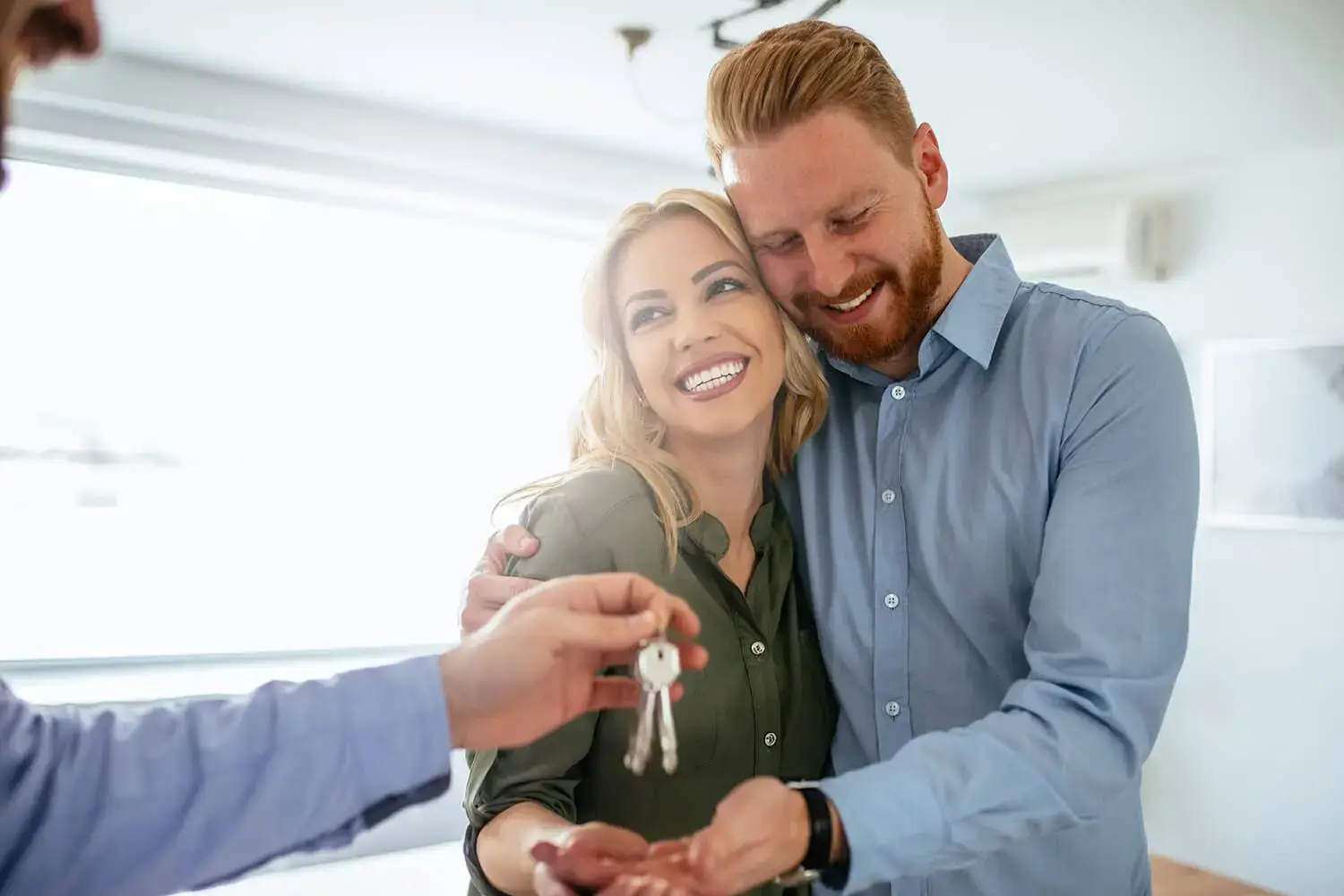 Real estate agent presenting options to a young couple at home